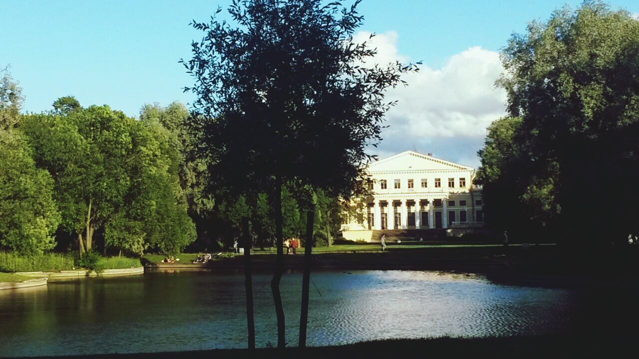 tree, building exterior, architecture, water, built structure, sky, waterfront, reflection, river, lake, growth, nature, cloud, house, day, tranquility, no people, outdoors, green color, canal