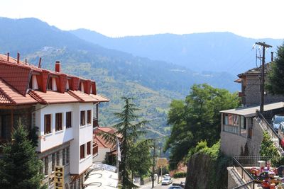 Buildings in town against mountains