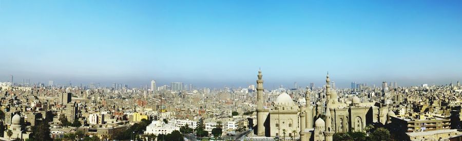 View of cityscape against blue sky