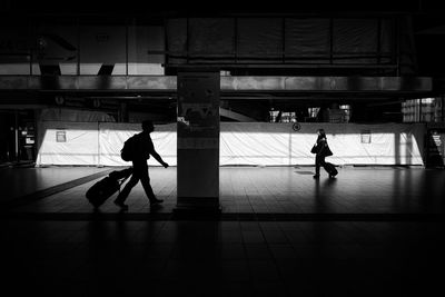 Rear view of silhouette woman walking in subway