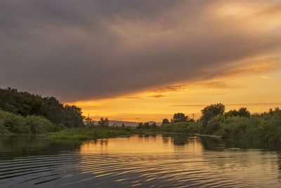 Scenic view of lake against sky during sunset