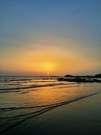 Scenic view of beach against sky during sunset