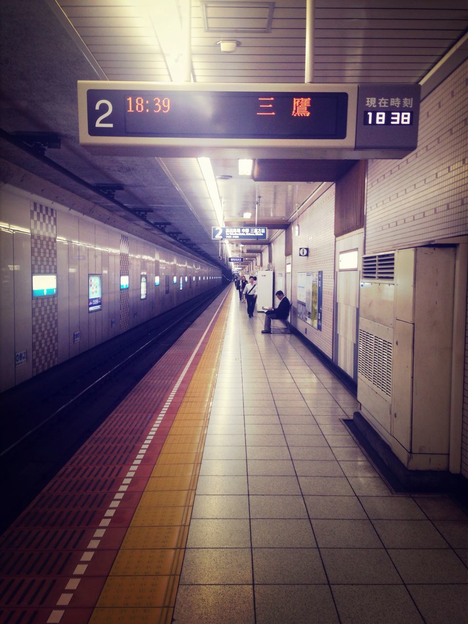 transportation, railroad station, public transportation, railroad station platform, railroad track, rail transportation, illuminated, indoors, subway station, the way forward, built structure, architecture, travel, public transport, diminishing perspective, train - vehicle, mode of transport, incidental people, subway, station