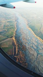 Cropped image of airplane flying over landscape