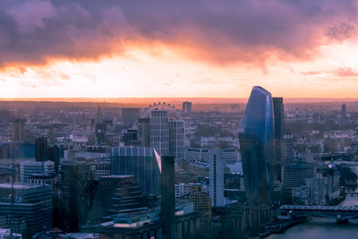 High angle view of modern buildings against sky during sunset