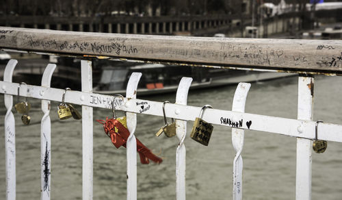 Close-up of padlocks hanging on railing