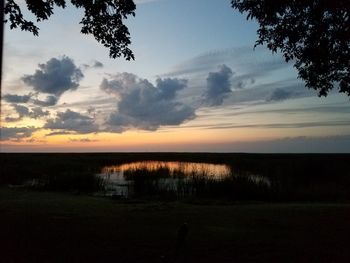 Scenic view of field against sky during sunset