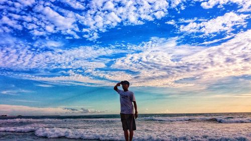 Rear view of man standing on beach