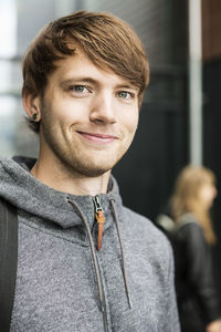 Portrait of young man smiling in university