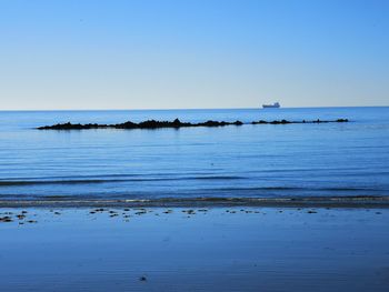 Scenic view of sea against clear blue sky