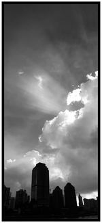 View of cityscape against cloudy sky