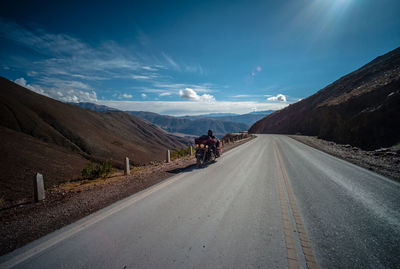 Empty road leading towards mountains