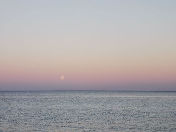 Scenic view of sea against clear sky during sunset