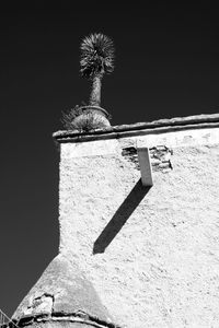 Low angle view of painting on wall against clear sky