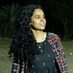 Portrait of young woman standing outdoors