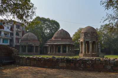 Built structure by trees against sky