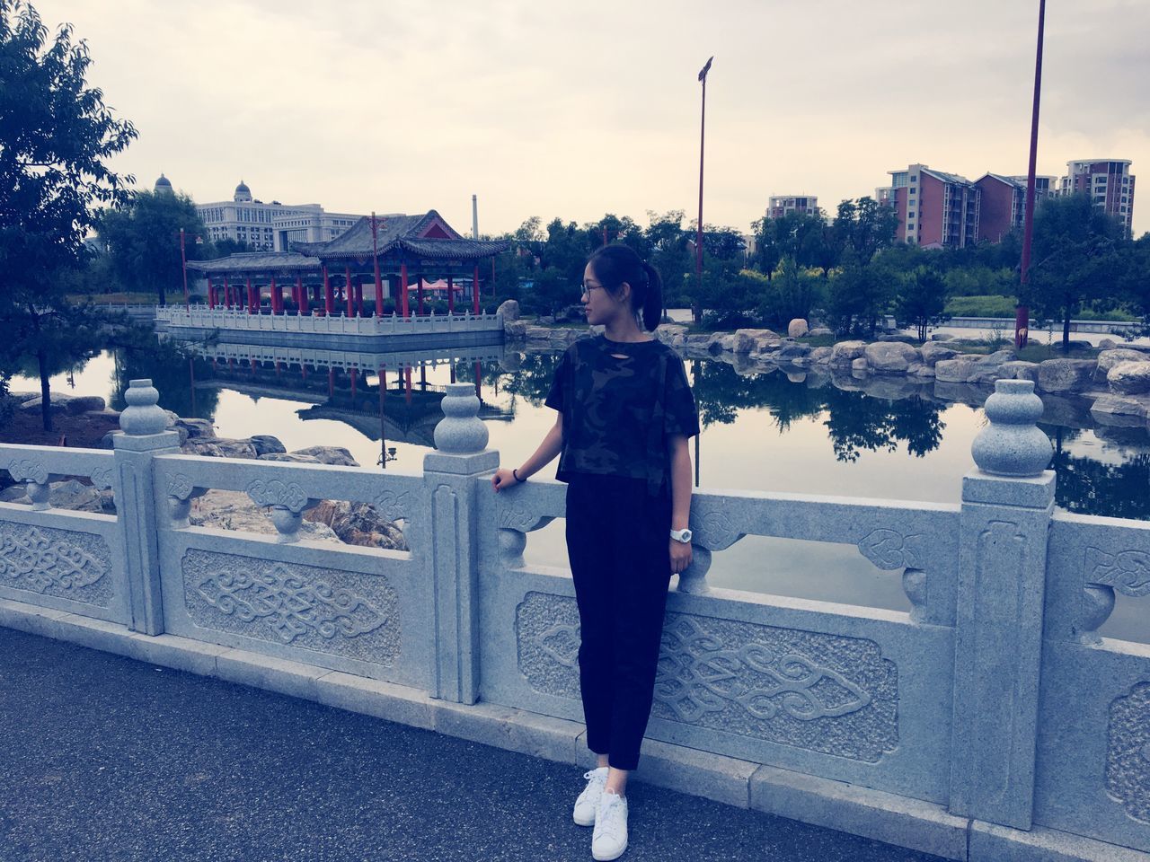 WOMAN STANDING IN FRONT OF RIVER