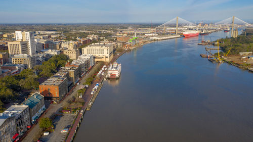 High angle view of river amidst buildings against sky