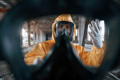 Low section of man standing in car