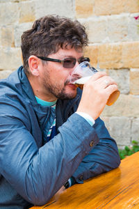 Close-up of man drinking beer