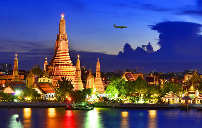 Illuminated temple against sky at night