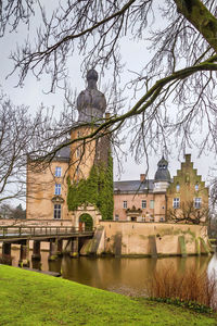 Arch bridge over river against buildings