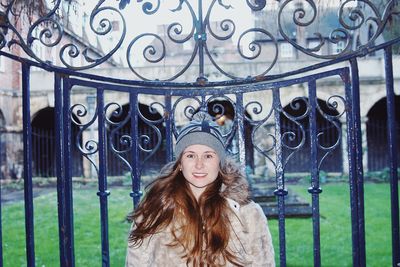 Portrait of a smiling young woman standing outdoors