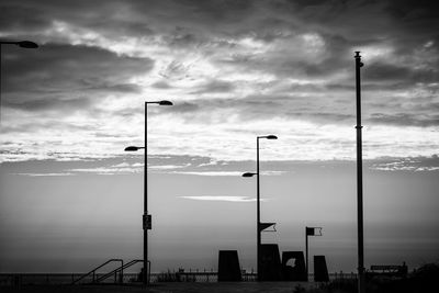 Low angle view of street lights against sky