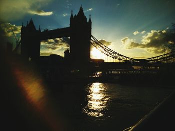 Bridge over river at sunset