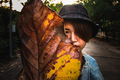 Close-up portrait of a girl with leaves