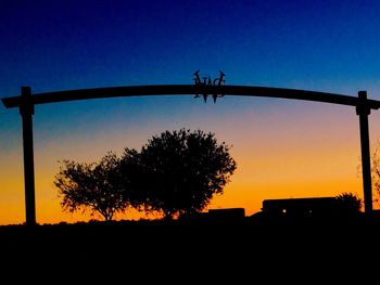 Silhouette trees against sky at sunset