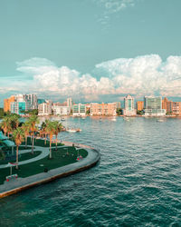 Scenic view of sea by buildings against sky