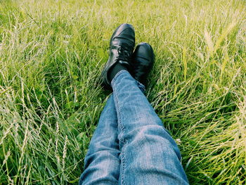 Low section of man sitting on field