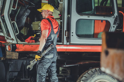 Rear view of man working at construction site