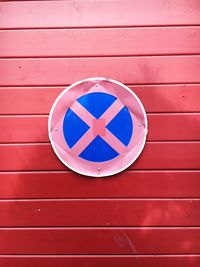 Road sign on red wall