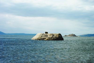 Scenic view of sea against cloudy sky