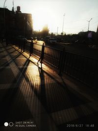 View of railroad station platform at sunset