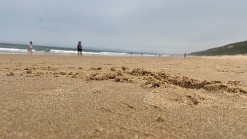 Surface level of beach against sky