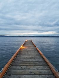 Pier over sea against sky