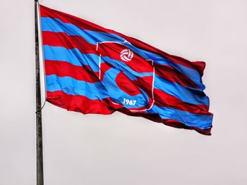 Low angle view of flag against clear sky