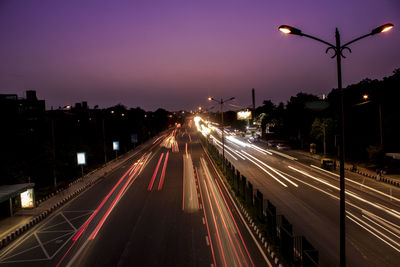 Light trails on road in city at night