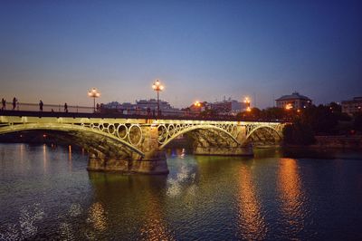 Bridge over river with city in background