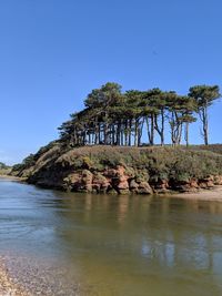 Scenic view of rocks against clear blue sky