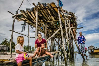 People standing by sea against sky