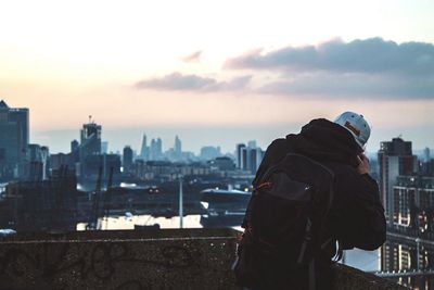 Man looking at view through binoculars