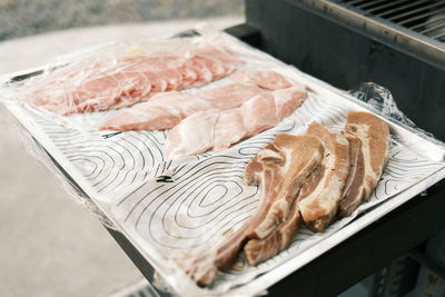 High angle view of meat on barbecue grill