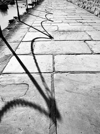 High angle view of shadow on footpath