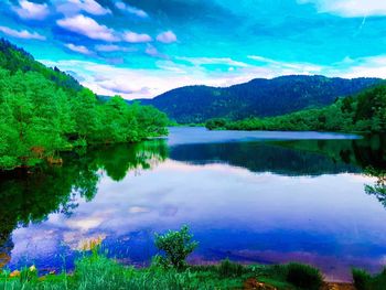 Scenic view of lake and mountains against sky