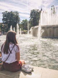 Rear view of woman enjoying in park