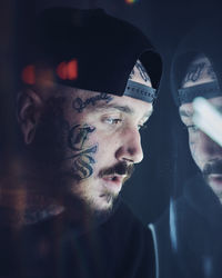 Close-up of young man with tattoo on face